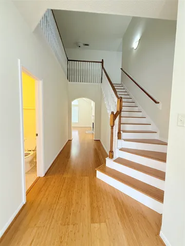 a view of entryway and hall with wooden floor