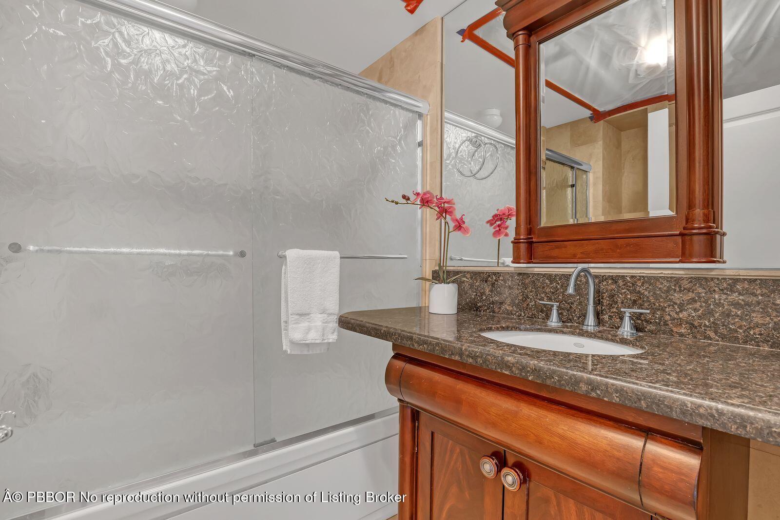 44 Cocoanut Row, Unit 420/421 A Palm Beach, FL 33480 - Photo 15 of 24 a bathroom with a granite countertop sink and a mirror