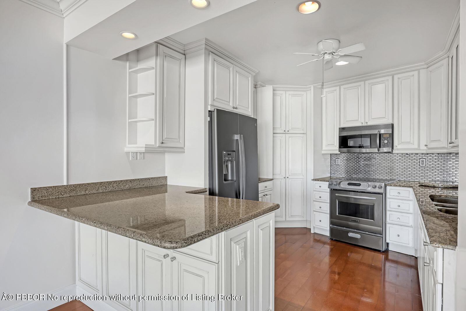 44 Cocoanut Row, Unit 420/421 A Palm Beach, FL 33480 - Photo 6 of 24 a kitchen with stainless steel appliances granite countertop a sink stove and refrigerator