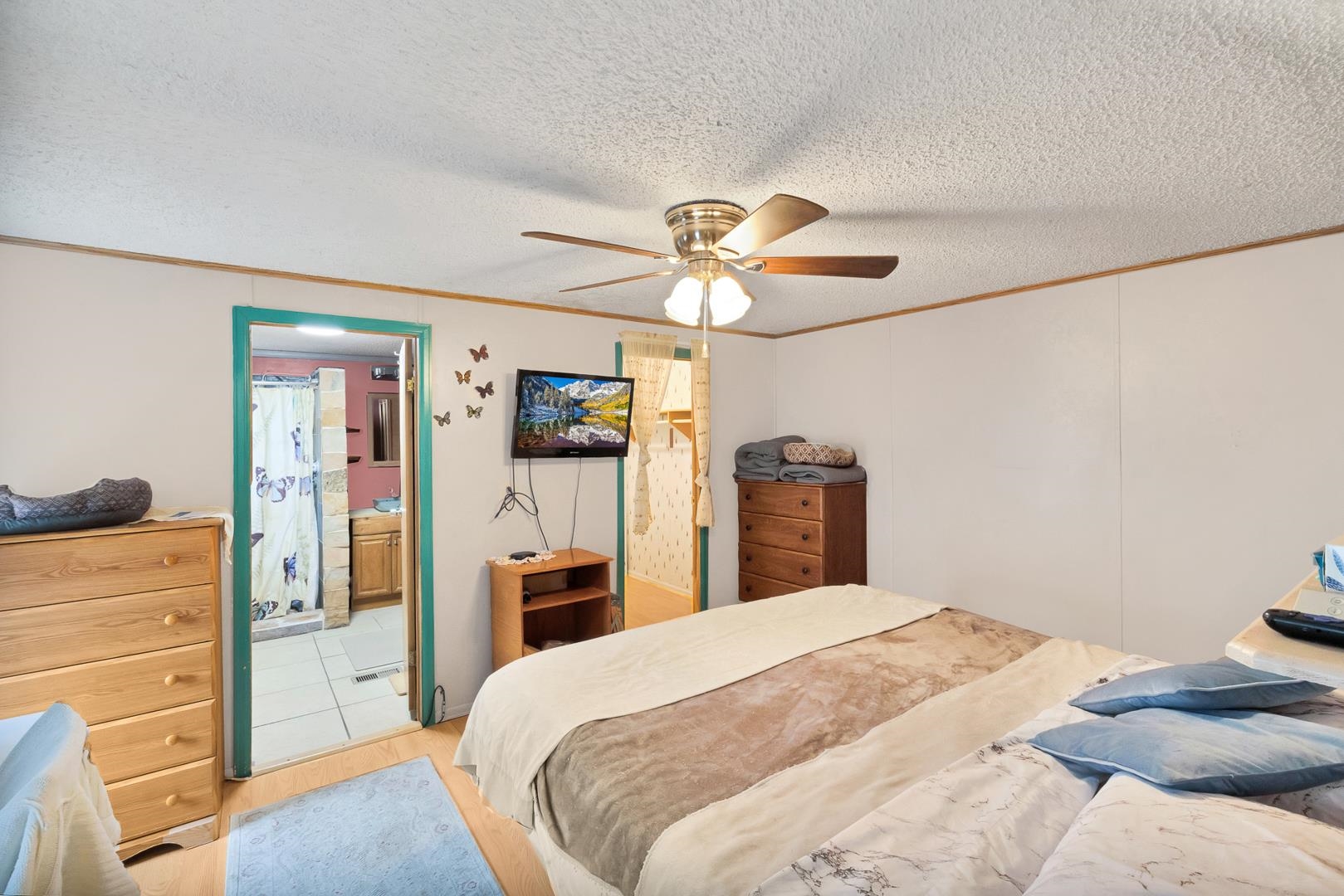 424 32 Road, Unit 271 Clifton, CO 81520 - Photo 16 of 29 a bedroom with a bed dresser and a chandelier