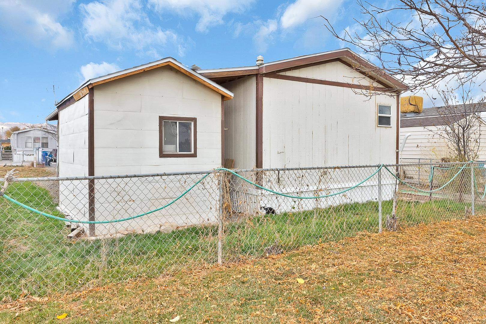 424 32 Road, Unit 271 Clifton, CO 81520 - Photo 4 of 29 a view of a house with a small yard and wooden fence