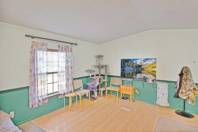 a bedroom with furniture and a wooden floor
