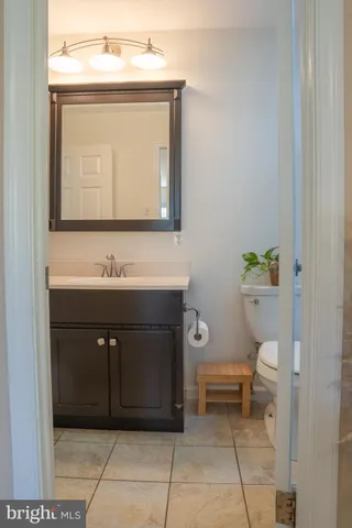 a bathroom with a sink a toilet and mirror