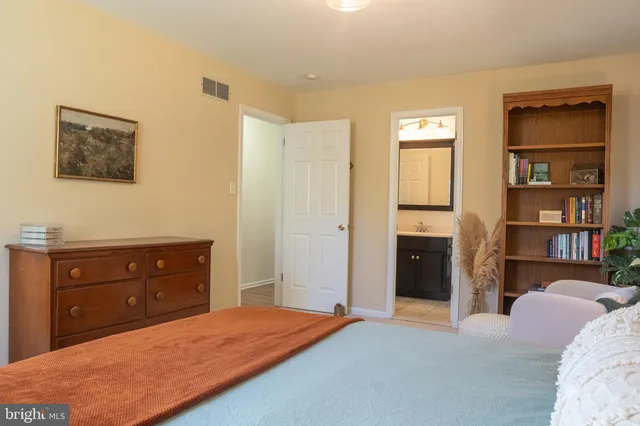 a bedroom with a bed and a dresser