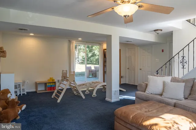 a bedroom with a bed and a ceiling fan