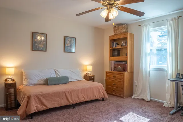 a view of a workspace with furniture and a book shelf