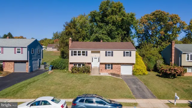 a view of a house with a yard and potted plants