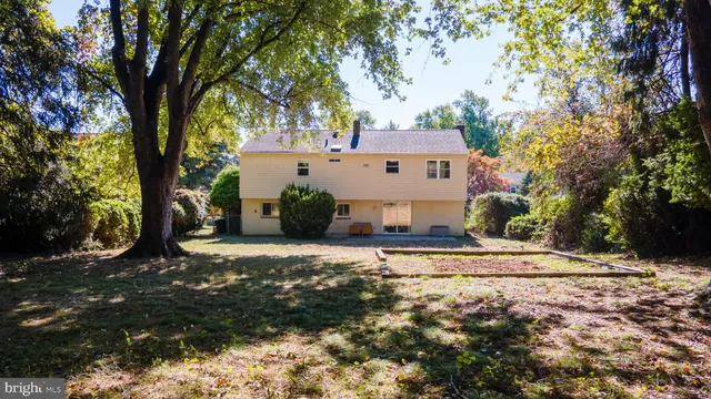 a view of a backyard with furniture and a garden