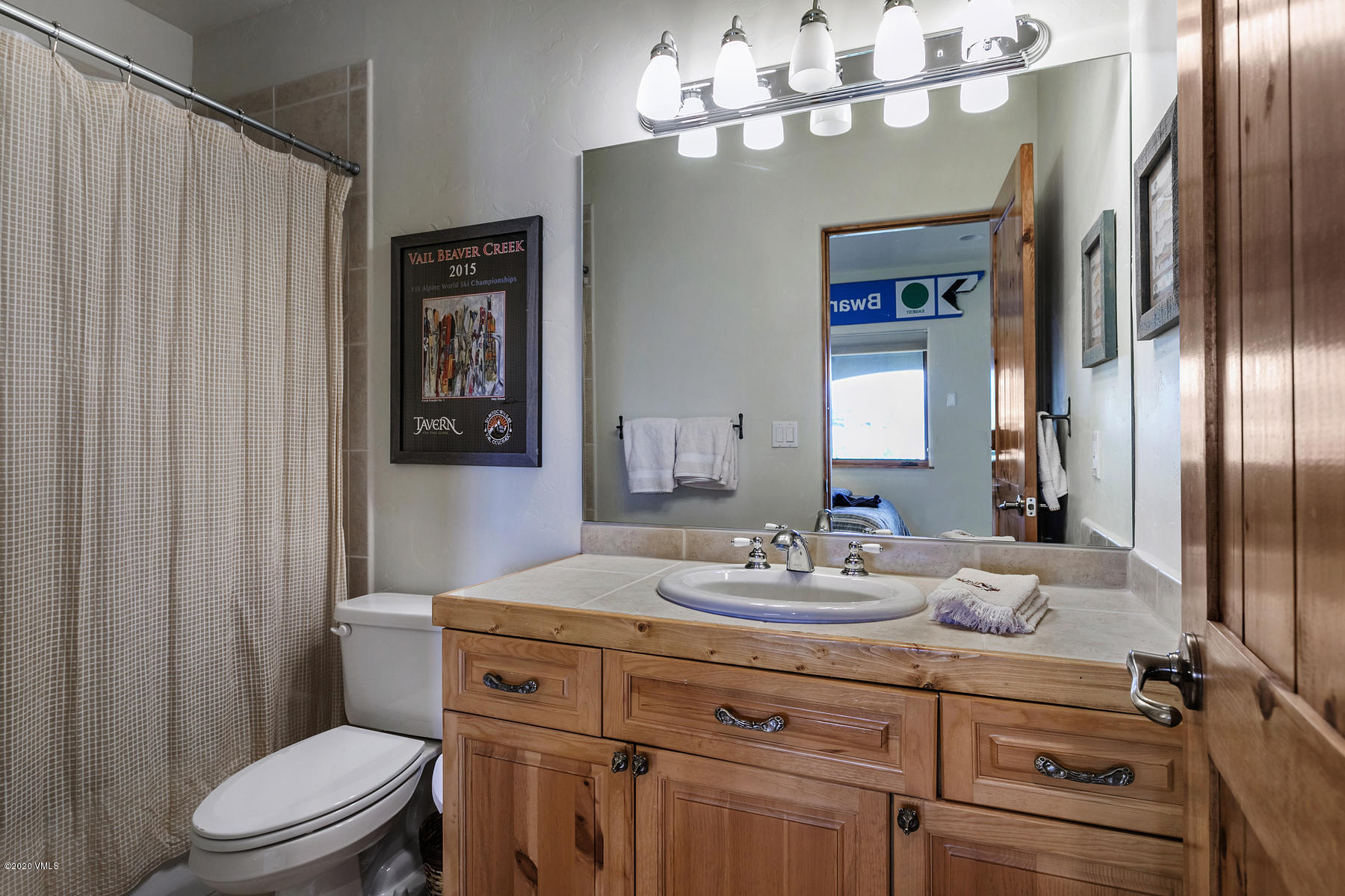 1581 Winslow Road, Unit A Edwards, CO 81632 - Photo 23 of 27 a bathroom with a sink a toilet and shower curtain