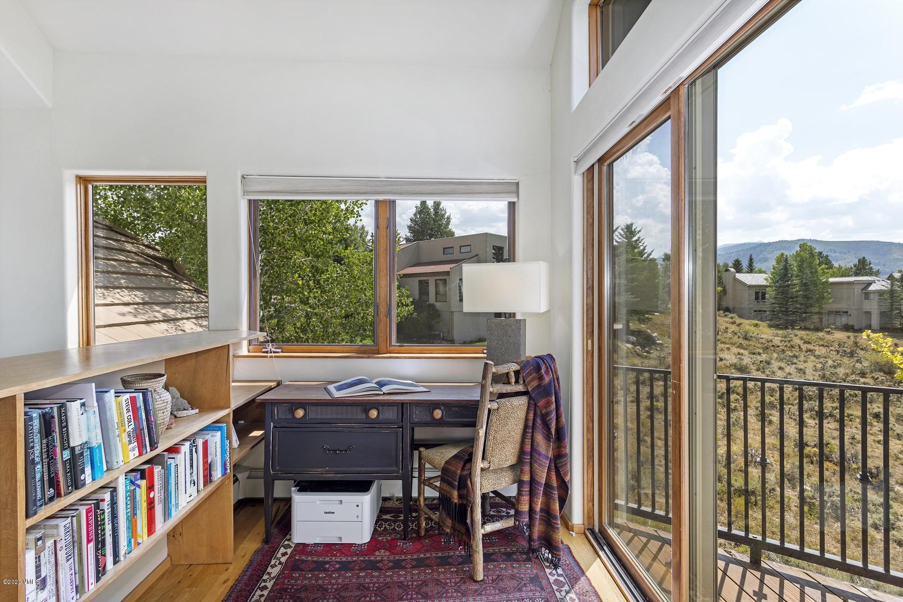 1581 Winslow Road, Unit A Edwards, CO 81632 - Photo 10 of 27 a view of a workspace with furniture and a book shelf