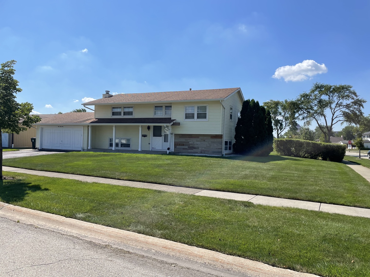 449 Yarmouth Road Elk Grove Village, IL 60007 - Photo 3 of 48 a front view of a house with a garden and yard