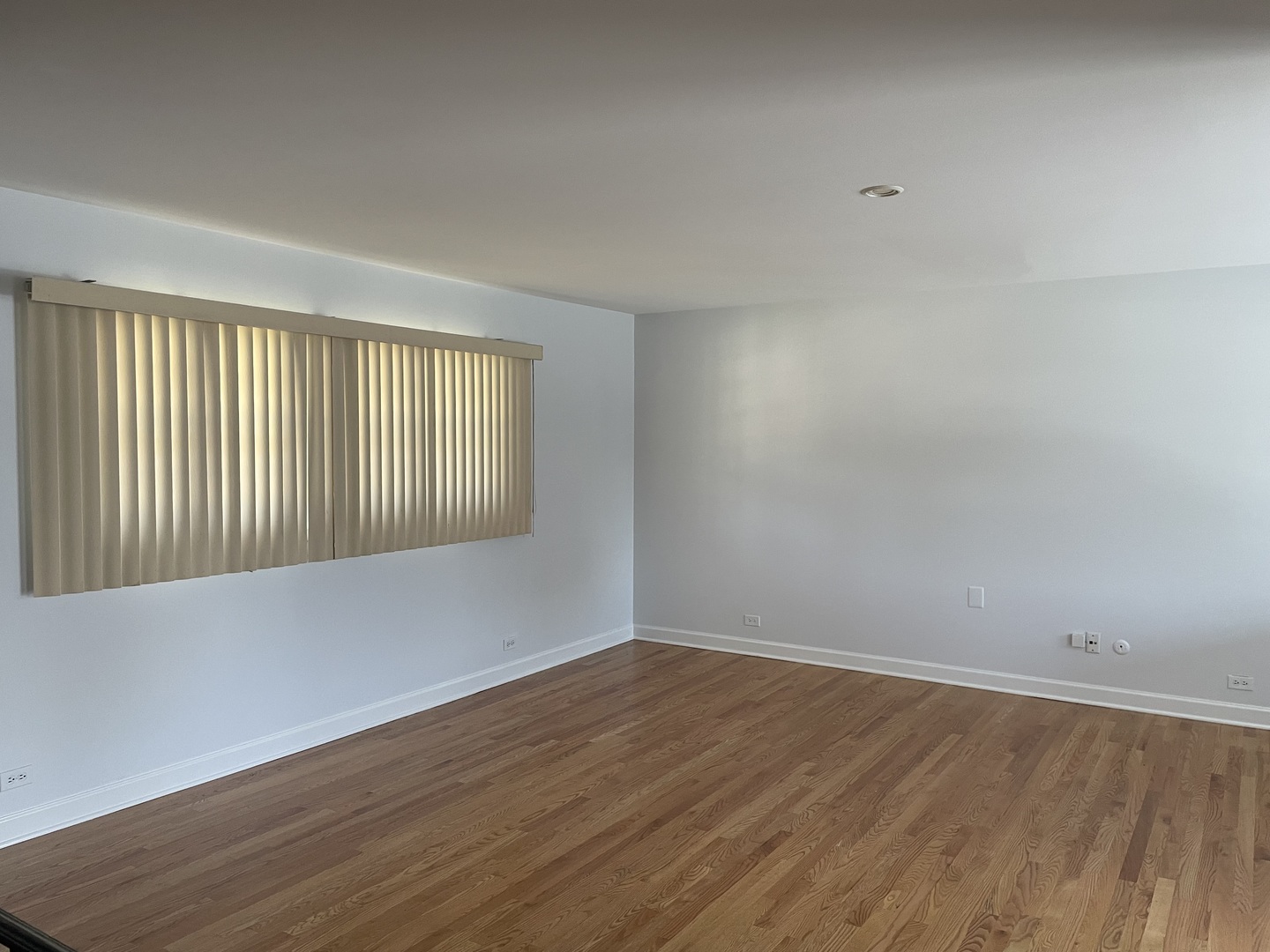 449 Yarmouth Road Elk Grove Village, IL 60007 - Photo 4 of 48 a view of an empty room with wooden floor and a window