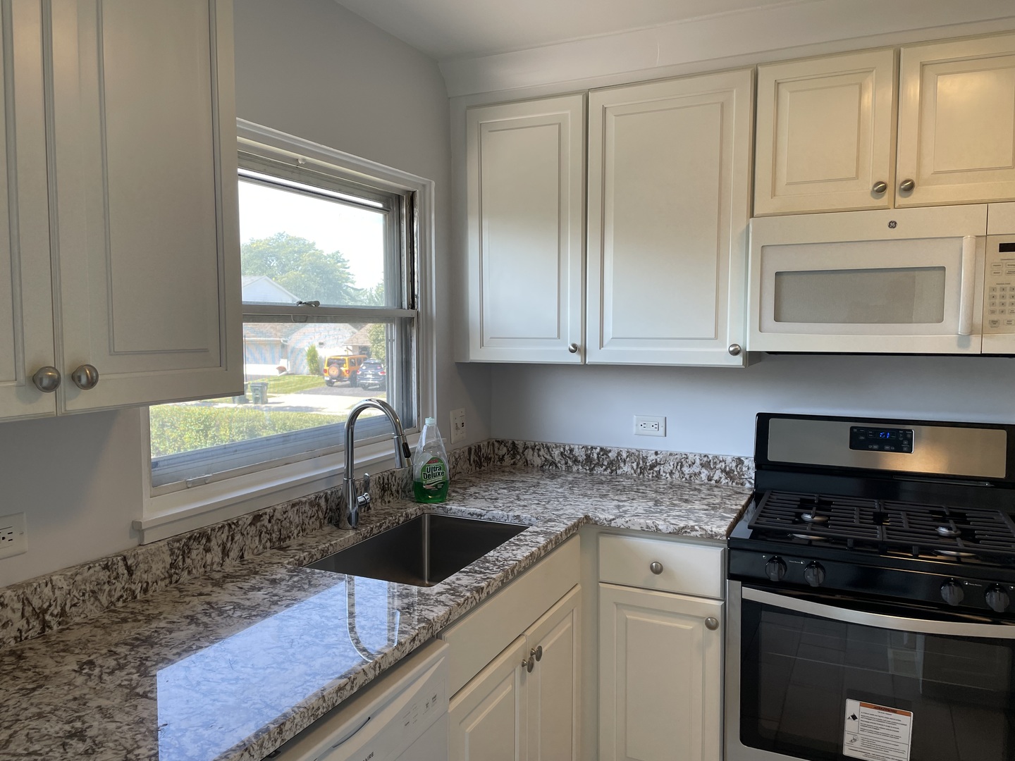 449 Yarmouth Road Elk Grove Village, IL 60007 - Photo 7 of 48 a kitchen with granite countertop a sink a stove and cabinets