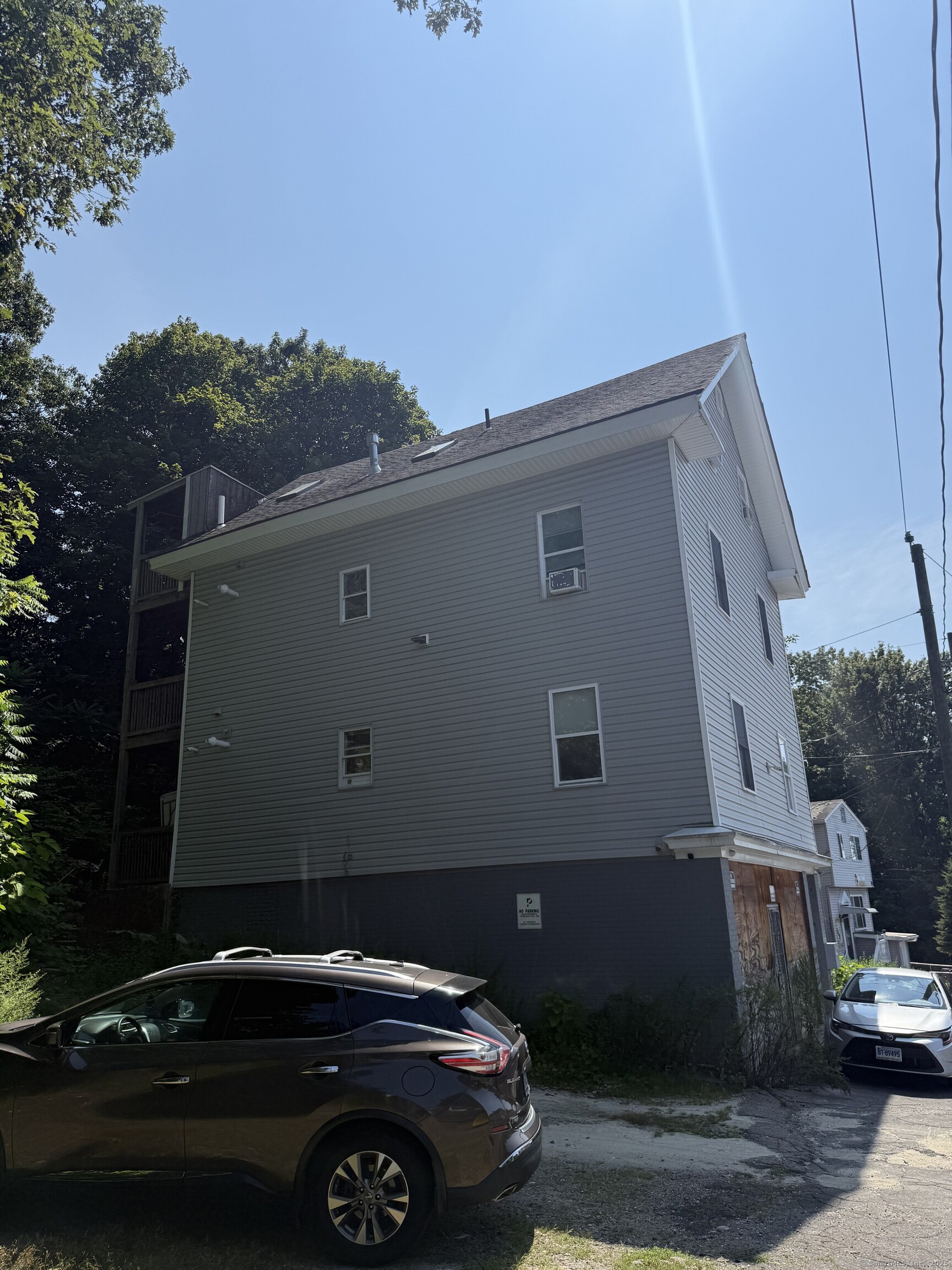 210 Bishop Street Waterbury, CT 06704 - Photo 3 of 9 a car parked in front of a house