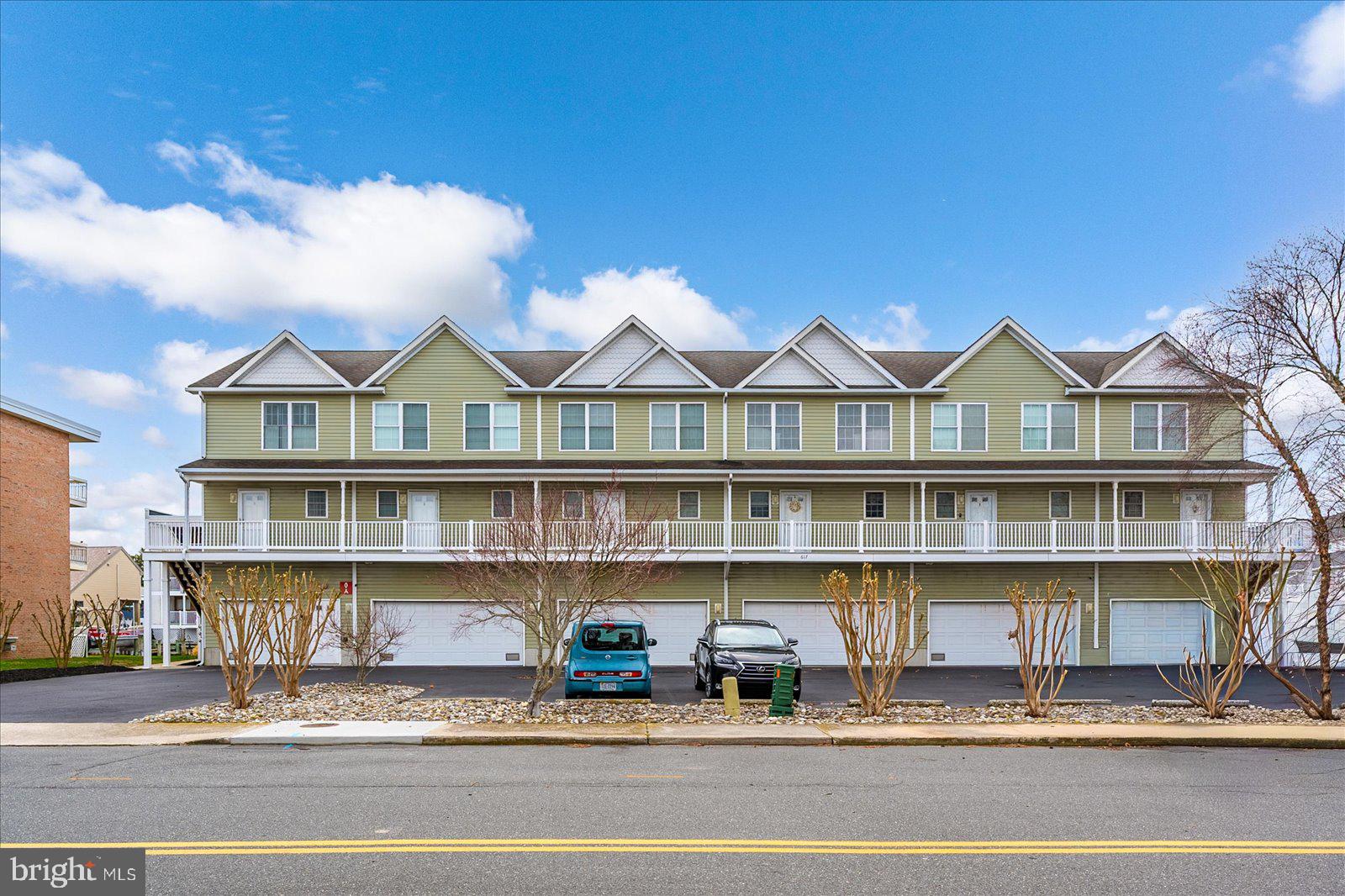 617 Salt Spray Road, Unit D Ocean City, MD 21842 - Photo 2 of 69 a front view of a building with a lot of windows