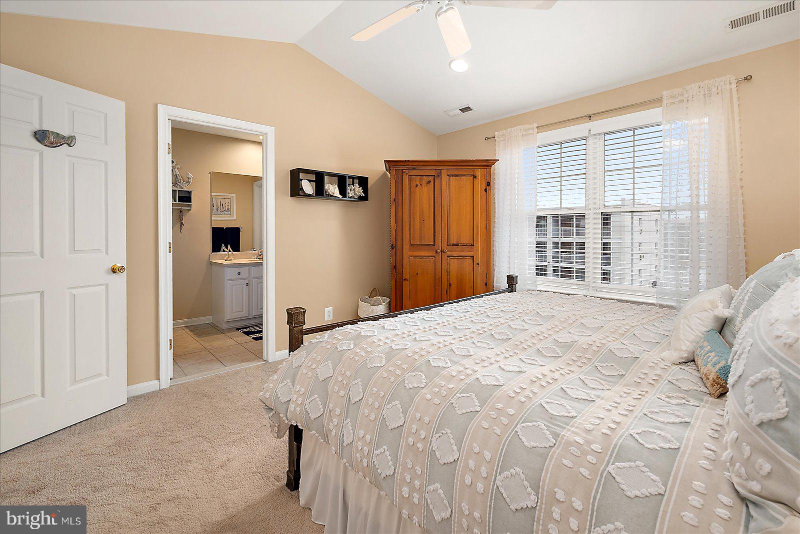 617 Salt Spray Road, Unit D Ocean City, MD 21842 - Photo 21 of 69 a bedroom with a bed and a window