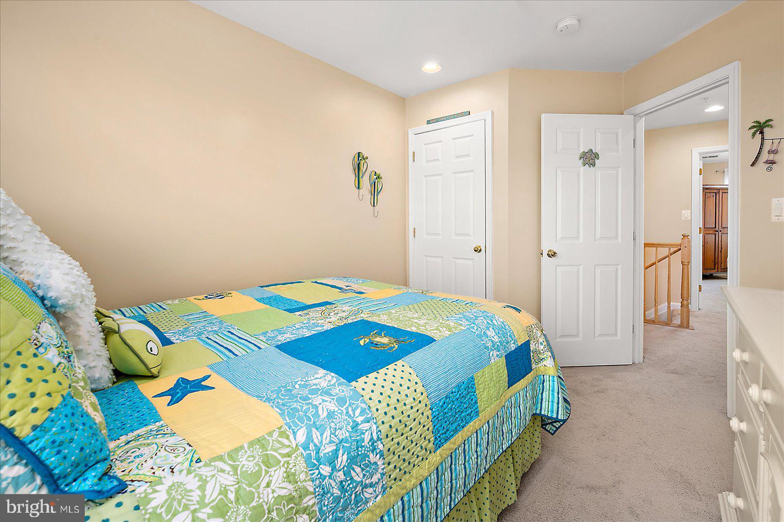 617 Salt Spray Road, Unit D Ocean City, MD 21842 - Photo 28 of 69 a bedroom with a bed and a lamp