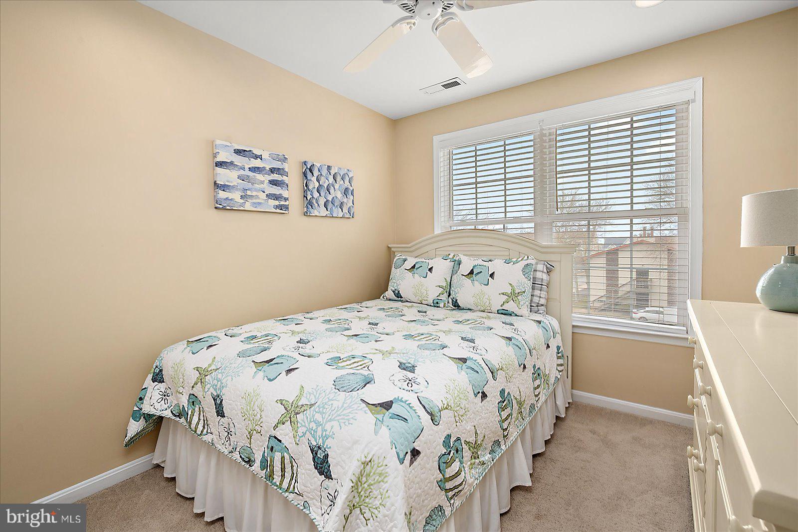 617 Salt Spray Road, Unit D Ocean City, MD 21842 - Photo 30 of 69 a bedroom with a bed and a window