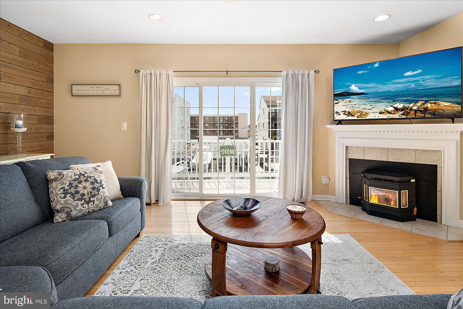 617 Salt Spray Road, Unit D Ocean City, MD 21842 - Photo 3 of 69 a living room with furniture and a fireplace