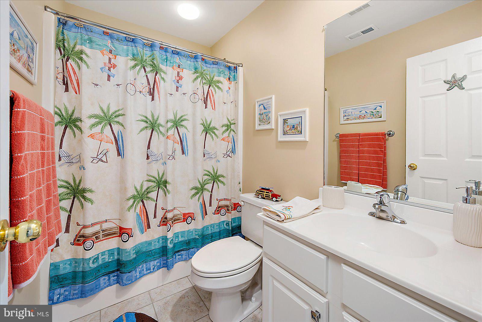 617 Salt Spray Road, Unit D Ocean City, MD 21842 - Photo 33 of 69 a bathroom with a sink mirror vanity and toilet