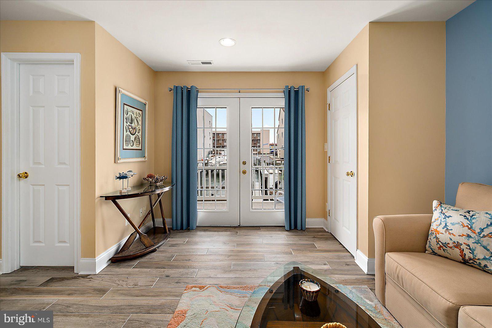 617 Salt Spray Road, Unit D Ocean City, MD 21842 - Photo 36 of 69 a view of a livingroom with furniture and floor to ceiling window