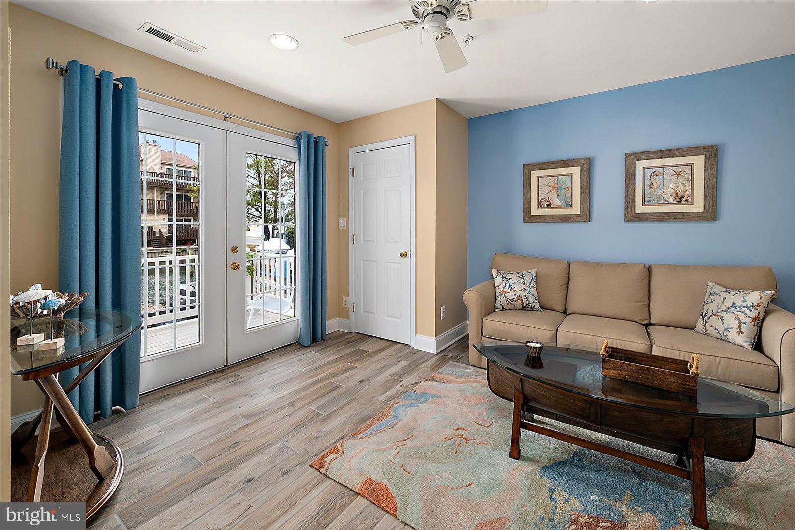617 Salt Spray Road, Unit D Ocean City, MD 21842 - Photo 37 of 69 a living room with furniture and wooden floor