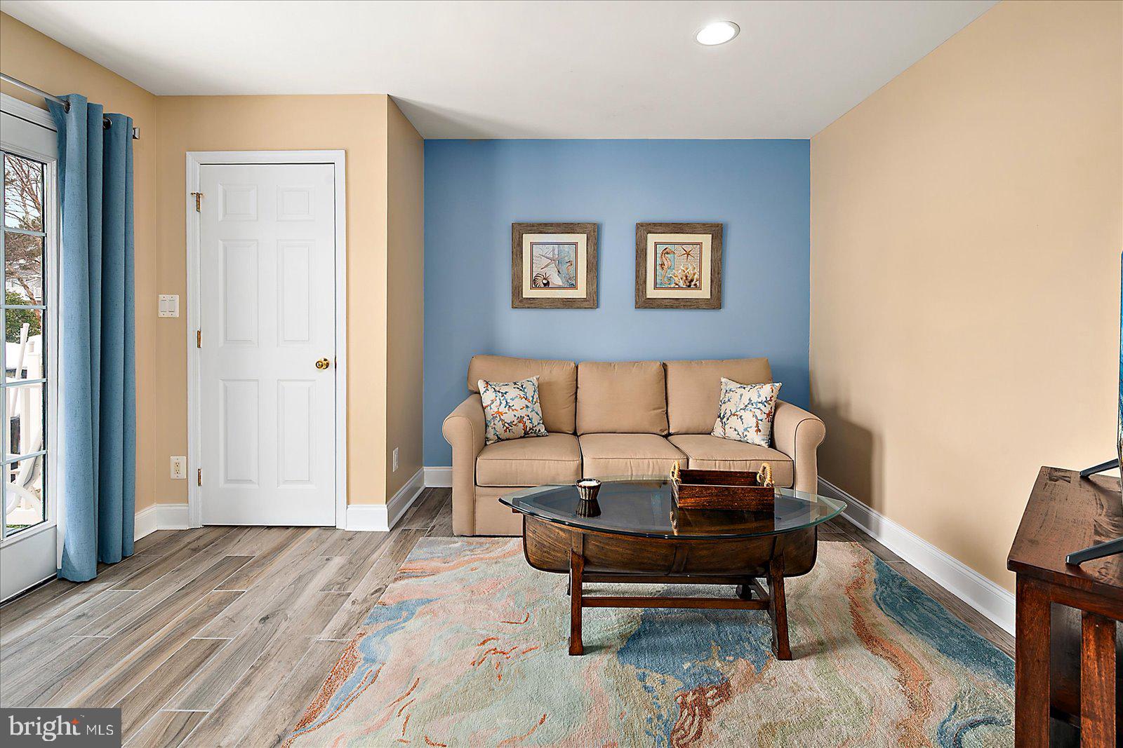 617 Salt Spray Road, Unit D Ocean City, MD 21842 - Photo 38 of 69 a living room with furniture and a wooden floor