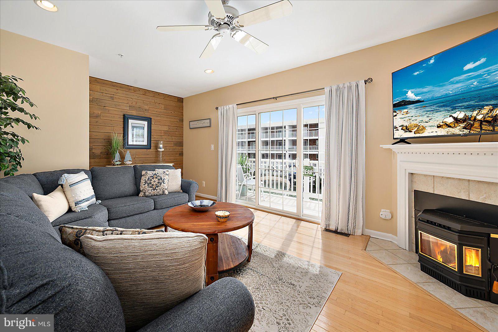 617 Salt Spray Road, Unit D Ocean City, MD 21842 - Photo 4 of 69 a living room with furniture and a fireplace