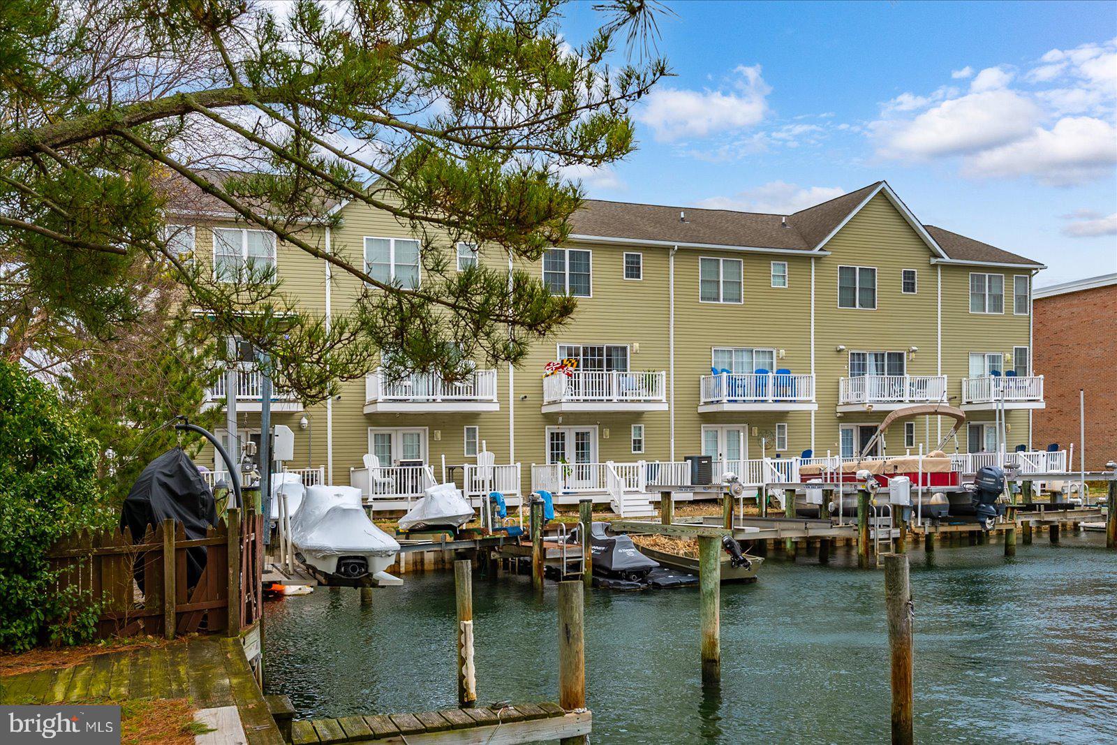 617 Salt Spray Road, Unit D Ocean City, MD 21842 - Photo 49 of 69 a aerial view of a house with swimming pool having outdoor seating