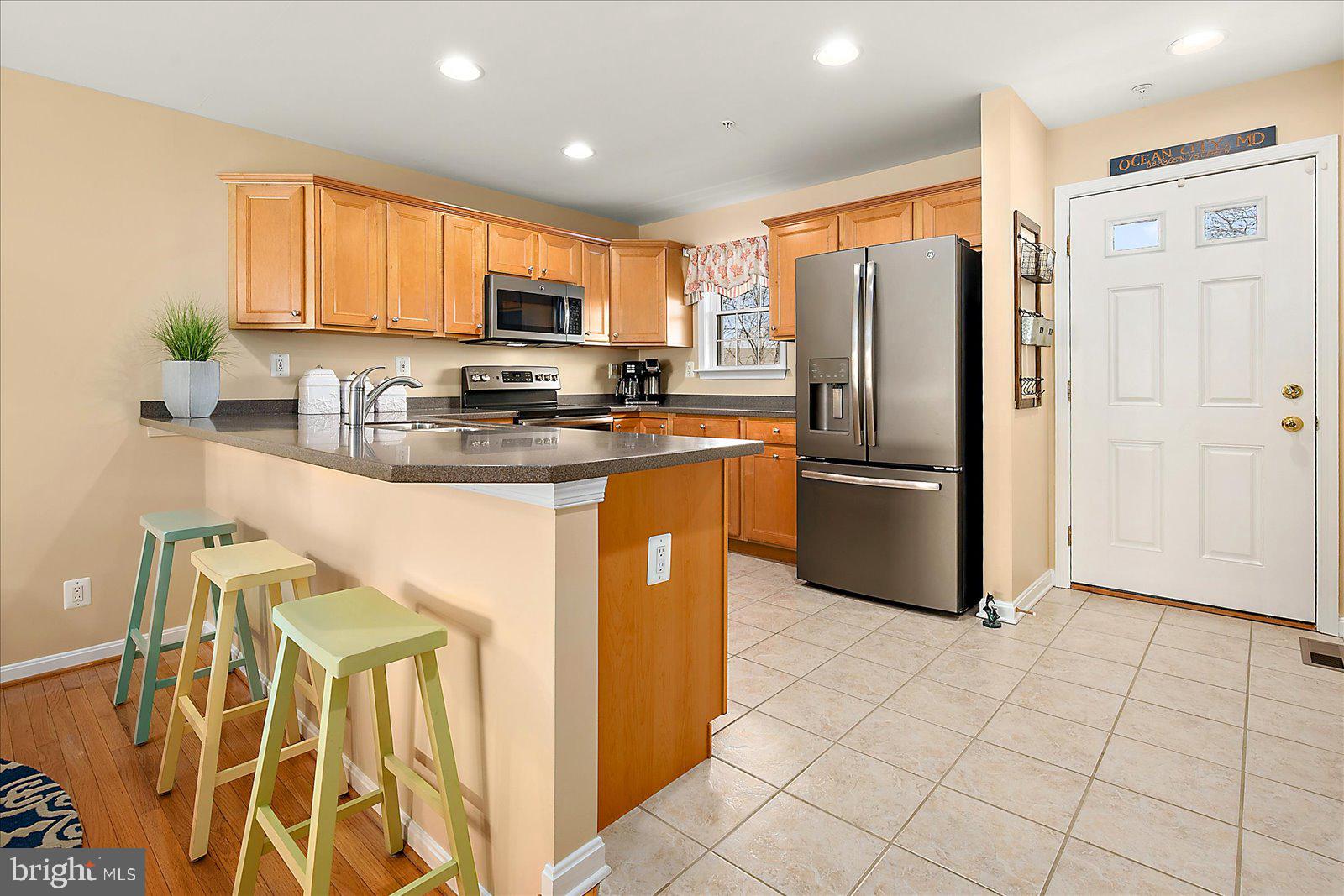 617 Salt Spray Road, Unit D Ocean City, MD 21842 - Photo 10 of 69 a kitchen with stainless steel appliances granite countertop a refrigerator and a stove top oven
