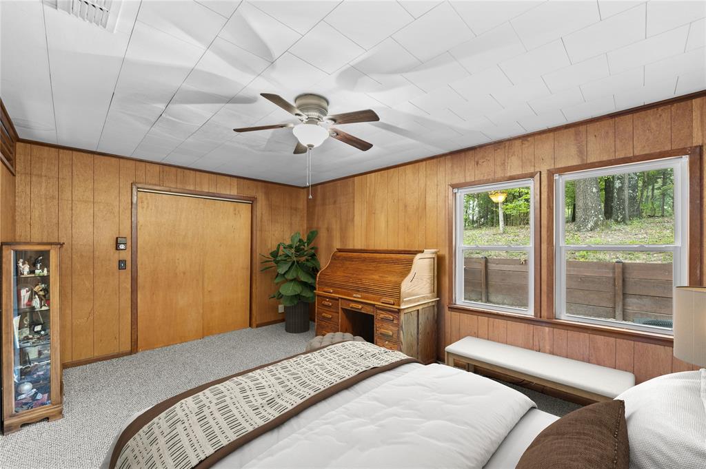 998 County Road 3230 Quitman, TX 75783 - Photo 14 of 24 a bedroom with a large bed and a chandelier