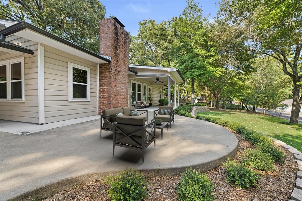 998 County Road 3230 Quitman, TX 75783 - Photo 4 of 24 a view of a house with backyard sitting area and garden