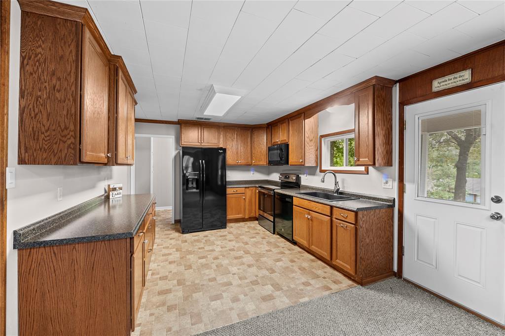 998 County Road 3230 Quitman, TX 75783 - Photo 9 of 24 a kitchen with stainless steel appliances granite countertop a refrigerator a stove top oven a sink and dishwasher