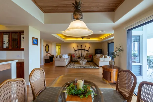 a living room with furniture and a chandelier