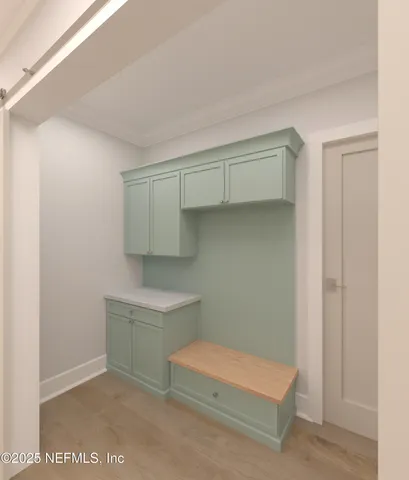 a view of a livingroom with a chandelier fan and windows