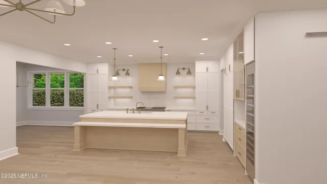 a large white kitchen with a large window