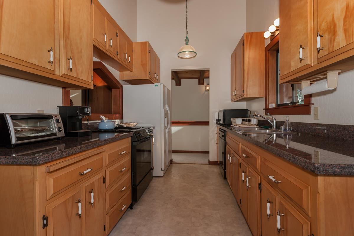 1311 Pine Trail Alpine Meadows, CA 96146 - Photo 5 of 14 a kitchen with stainless steel appliances granite countertop a sink a stove and a refrigerator
