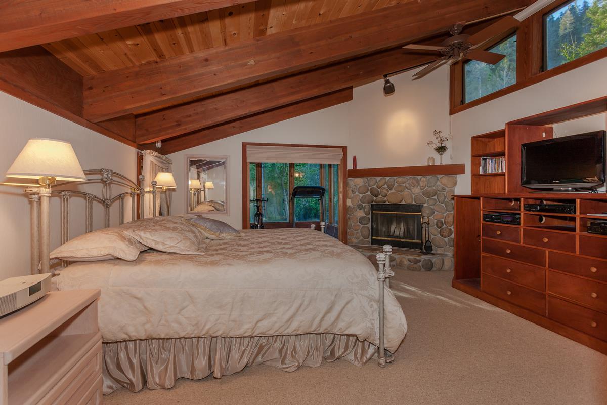 1311 Pine Trail Alpine Meadows, CA 96146 - Photo 8 of 14 a bedroom with a bed and a television