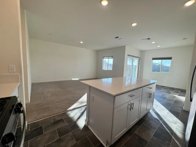 a kitchen with a stove and white cabinets