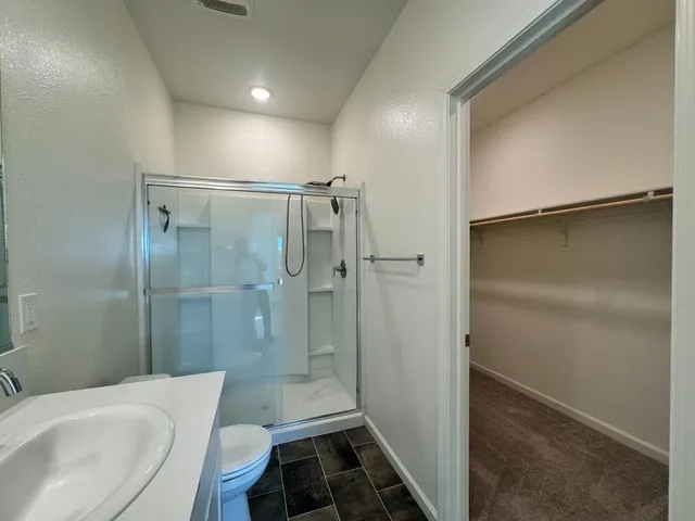 a bathroom with a shower and a toilet