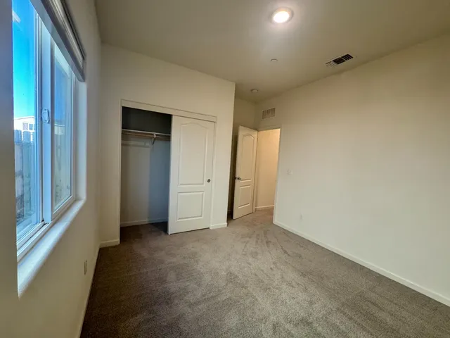 a view of an empty room and a window