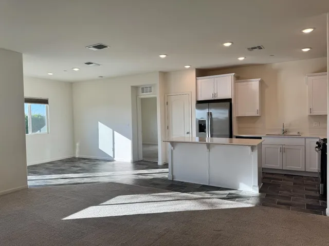 a kitchen with granite countertop a sink and cabinets