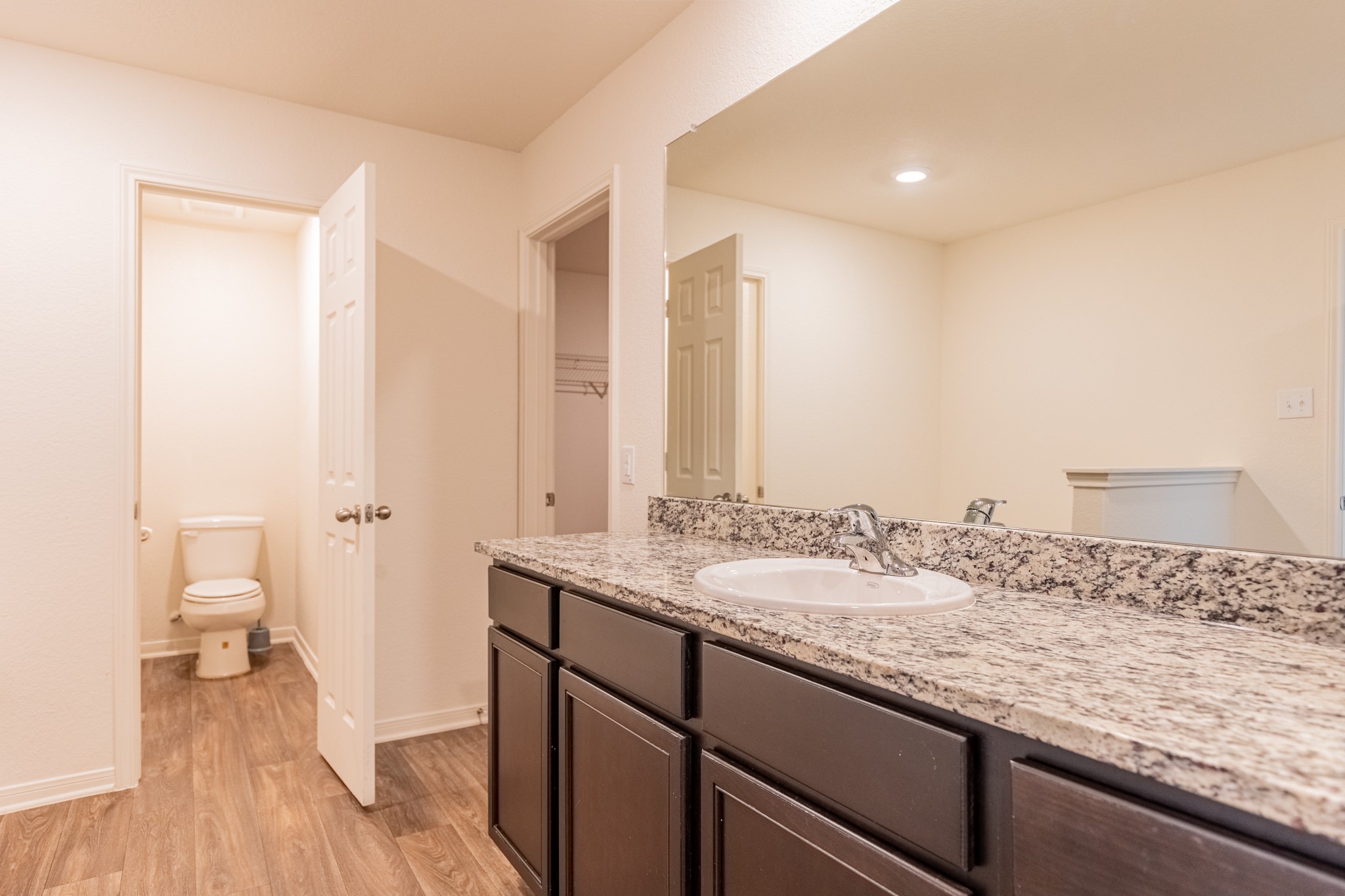 18628 Quiet Range Drive Elgin, TX 78621 - Photo 15 of 32 a bathroom with a granite countertop sink and a mirror