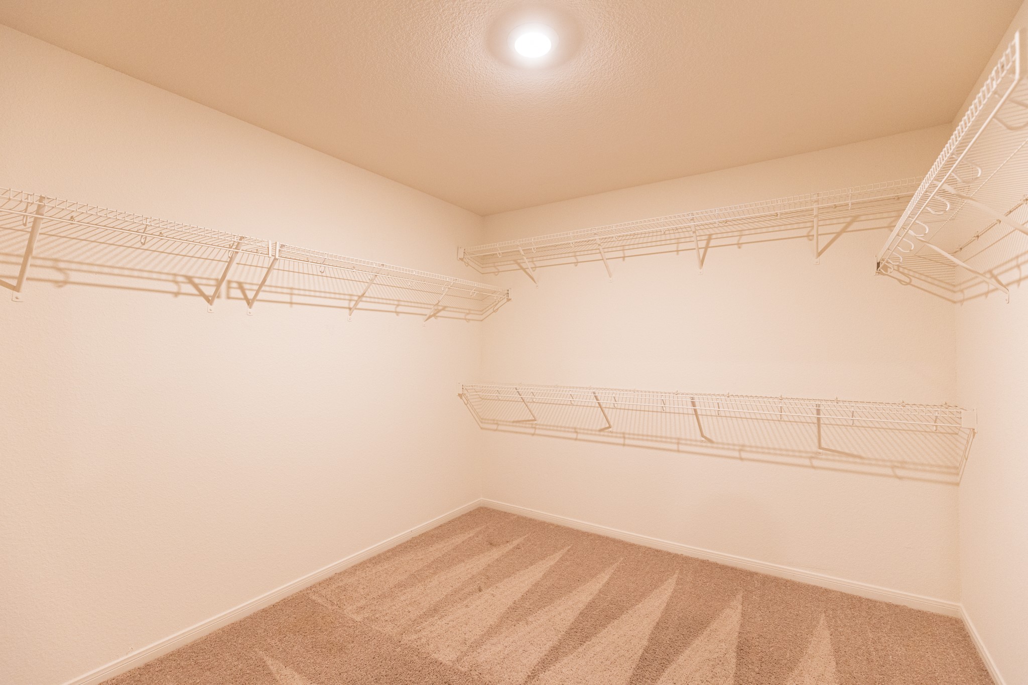 18628 Quiet Range Drive Elgin, TX 78621 - Photo 18 of 32 a view of a room with racks on the wall