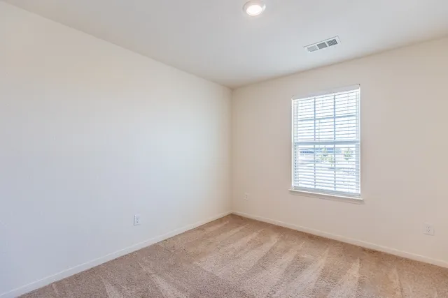 a view of an empty room and closet area
