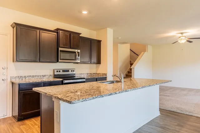 a kitchen with a stove a sink and a microwave