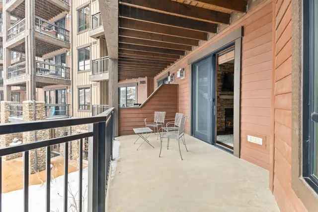 a view of a patio with a table and chairs and wooden floor