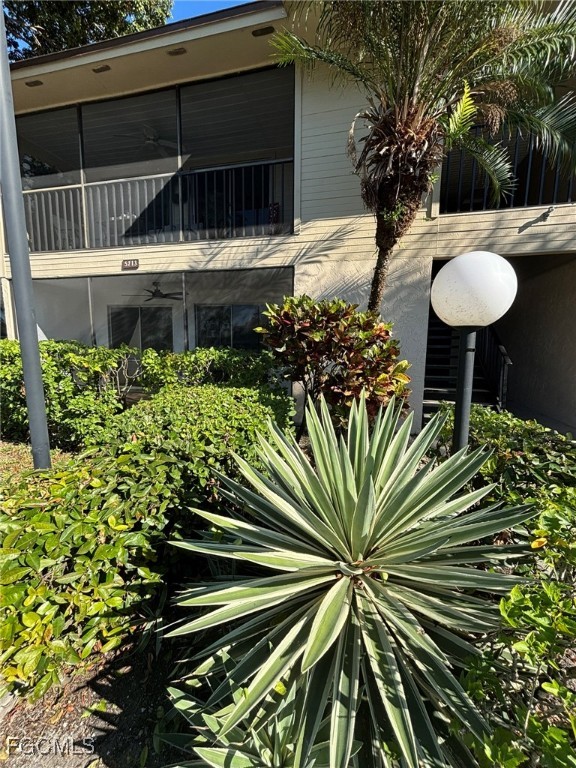 5713 Foxlake Drive, Unit 1 North Fort Myers, FL 33917 - Photo 2 of 10 a view of a backyard with a fountain plants and large tree