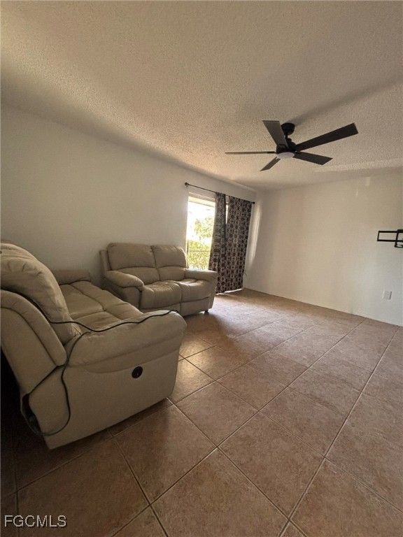 5713 Foxlake Drive, Unit 1 North Fort Myers, FL 33917 - Photo 3 of 10 a living room with furniture and a ceiling fan