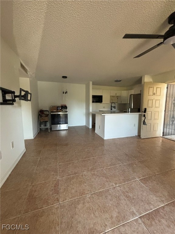 5713 Foxlake Drive, Unit 1 North Fort Myers, FL 33917 - Photo 4 of 10 a view of a kitchen with furniture and a refrigerator
